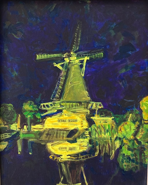 Molen de Ster by night reflecting in the water in purple, yellow and green